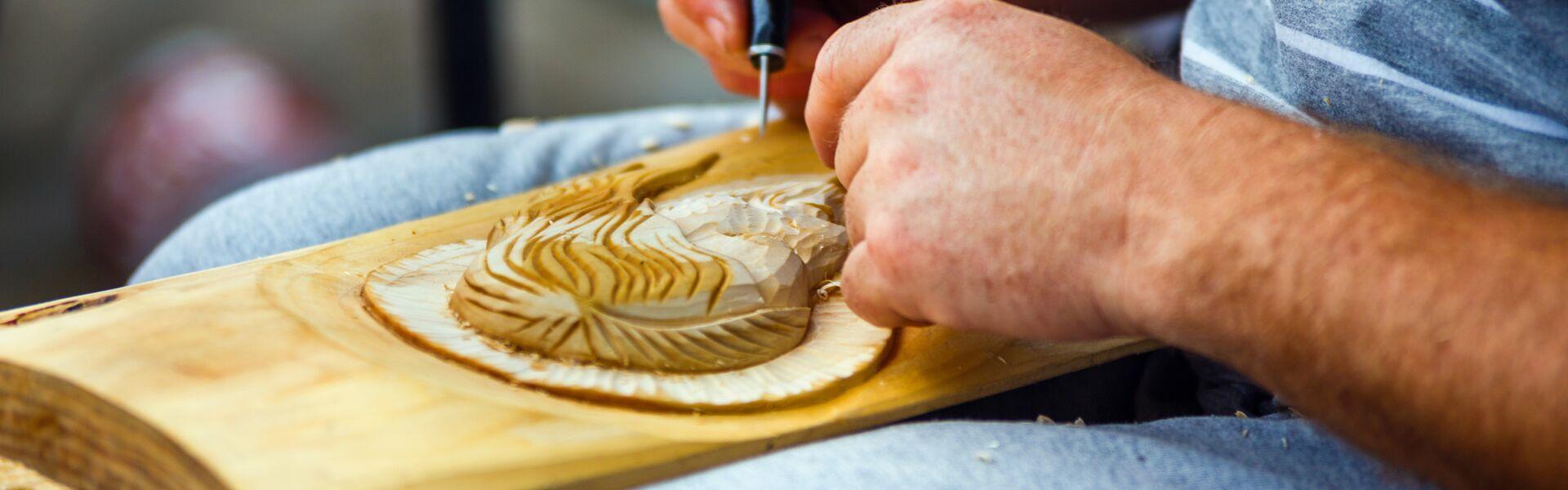 person carving wood