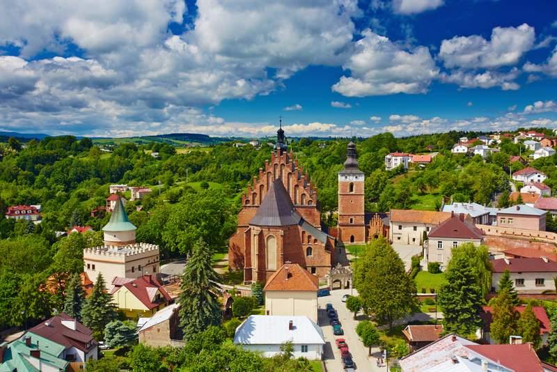 panorama miasta Biecz, strzelisty ceglany kościół jako główny obiekt, zabudowania wokół